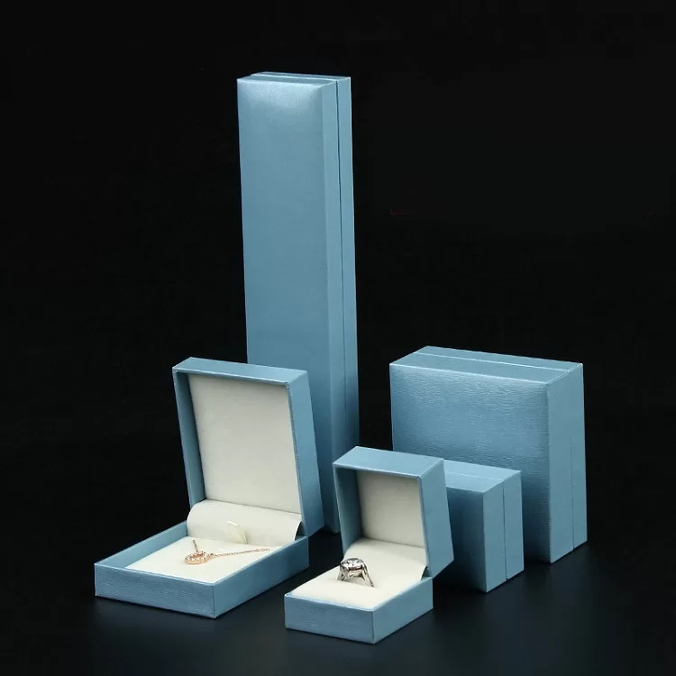 Large square blue jewelry set box with sharp edges for necklaces.