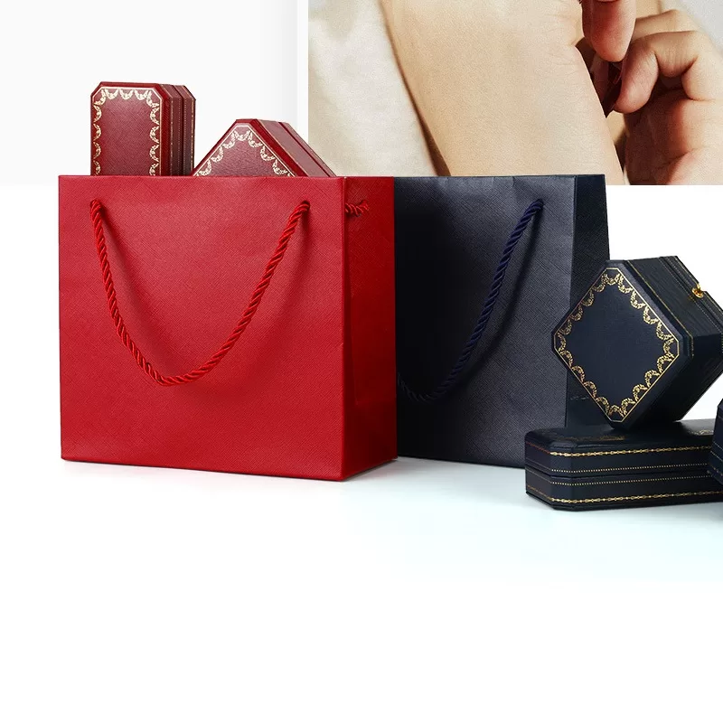 Classic red octagonal ring box with gold button fastener open view