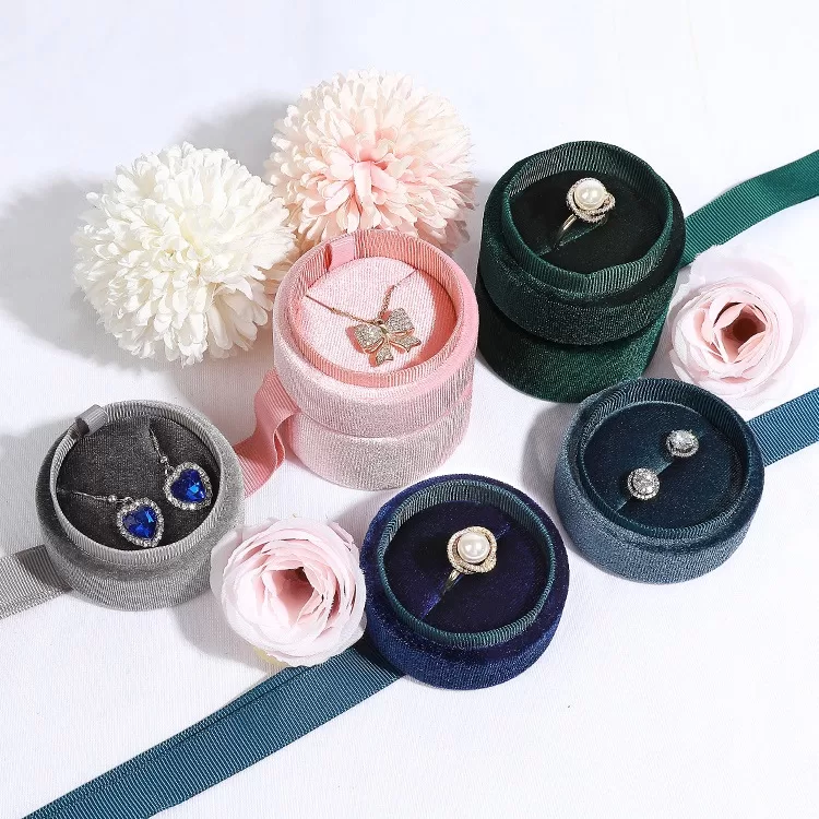 Open view of round ribbon jewelry box with velvet insert