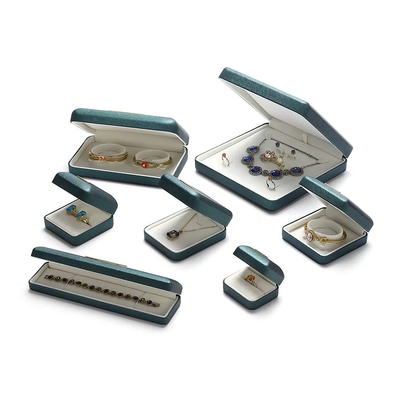 Open iron-core ring box with cream velvet interior showing craftsmanship.