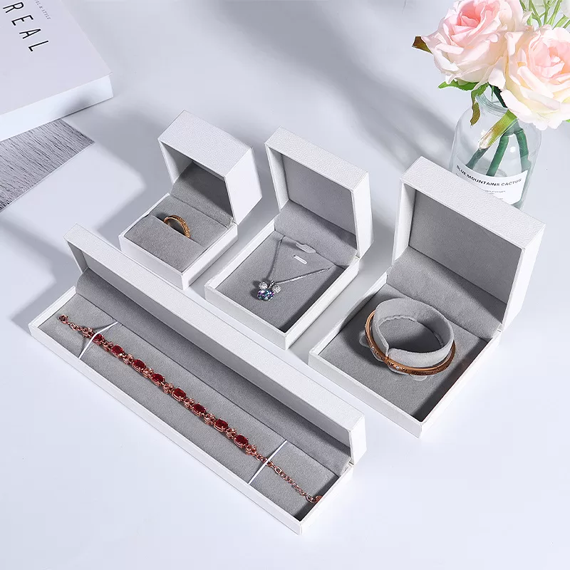 Pure white textured paper jewelry box with sharp right-angle design.