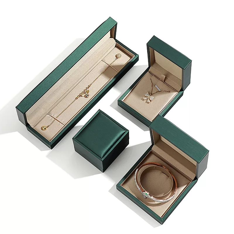 Set of emerald green rigid jewelry boxes with sharp corners.
