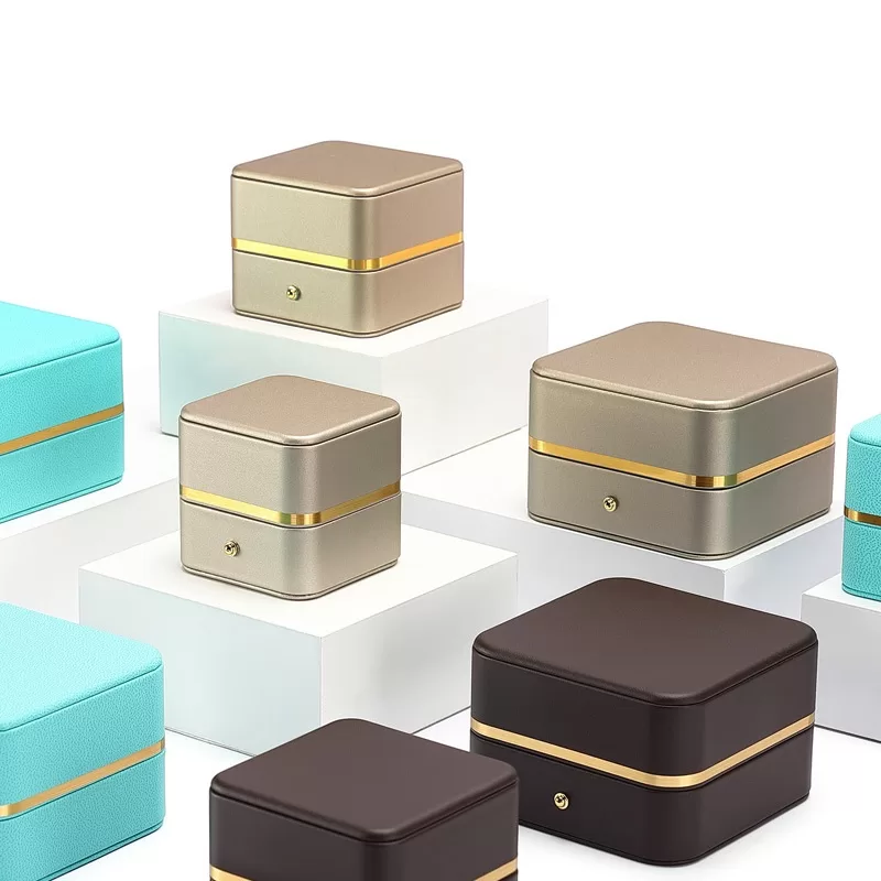 Wholesale collection of tiny style jewelry boxes in white, blue, and green PU leather.