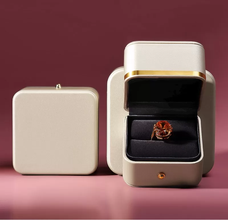 Open view of plush velvet interior inside round jewelry box.