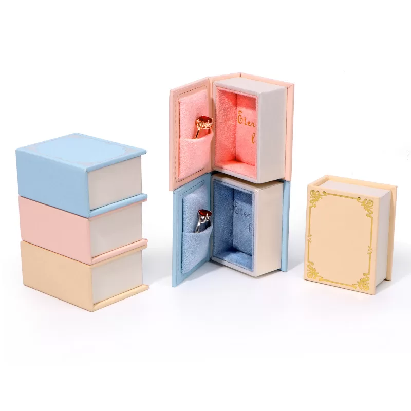 Stack of pink creative book shaped jewelry packaging boxes for bulk order