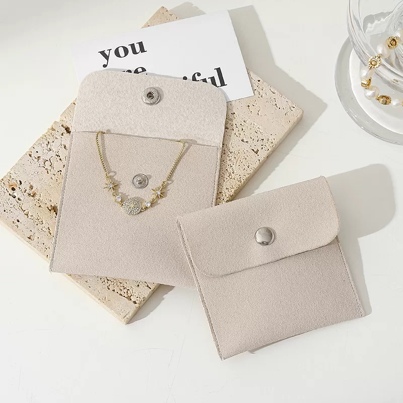 Open envelope jewelry pouch displaying necklace storage