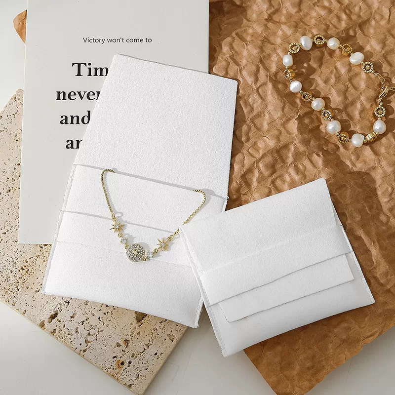 Open microfiber jewelry bag showing strap closure mechanism