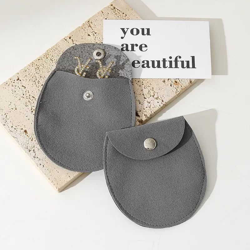 Open oval jewelry pouch displaying interior capacity