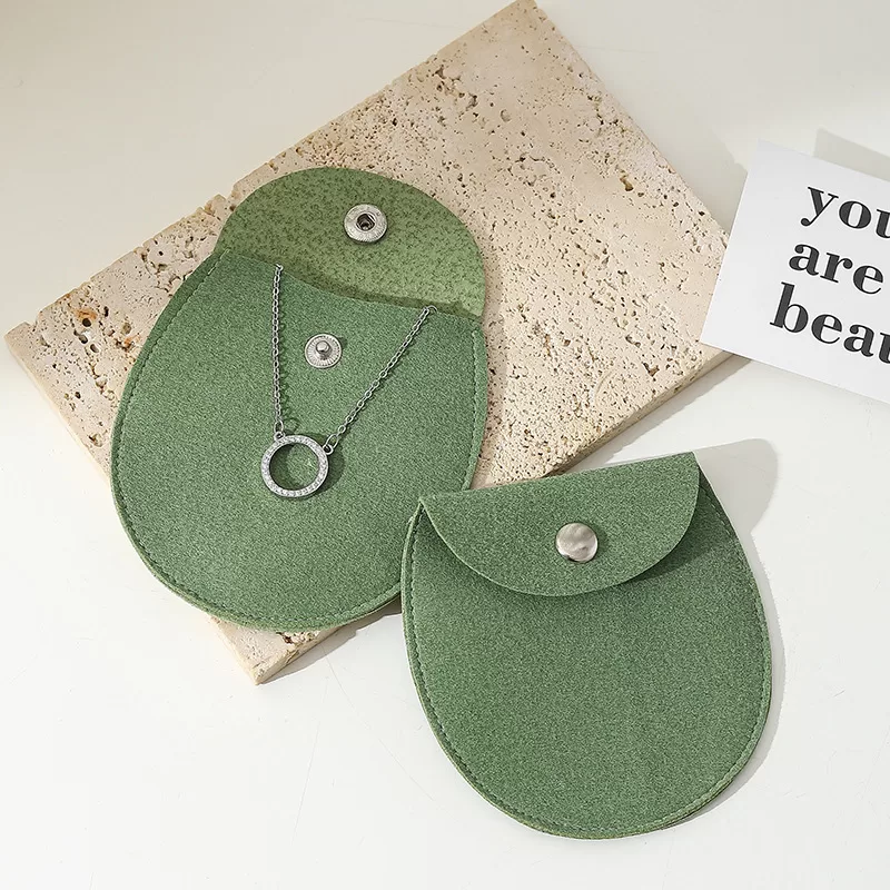 Beige microfiber snap jewelry pouch with oval bottom for necklace storage