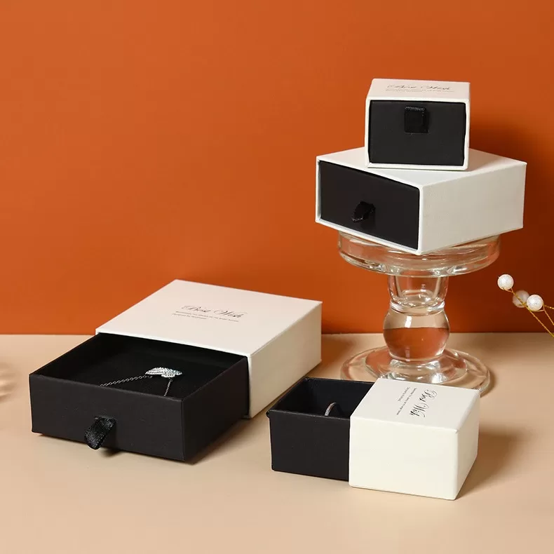 Smooth satin ribbon pull tab on cardboard drawer box for easy opening