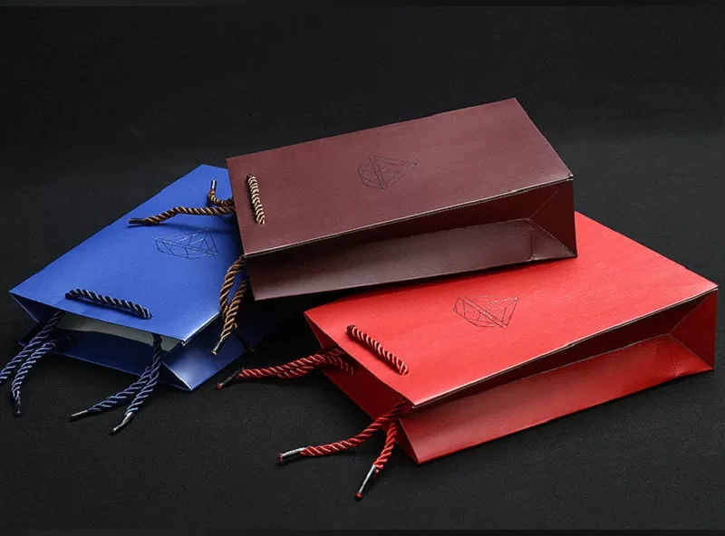 Close up of vertical embossed texture on golden paper jewelry bag.