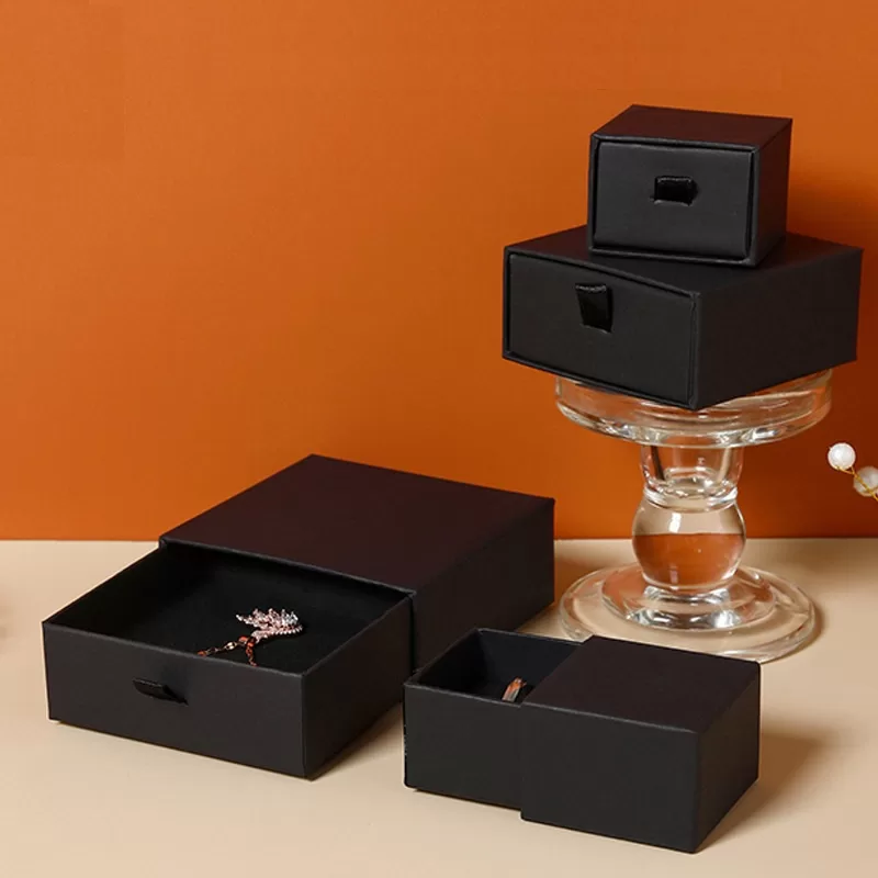 Diamond ring displayed inside a premium black cardboard drawer box