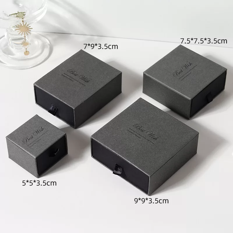 Side view of rigid black cardboard slide box showing reinforced thickness