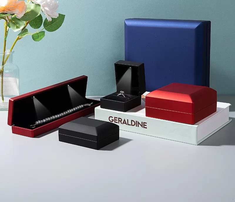 Wholesale set of matte red and blue LED lighted jewelry boxes.