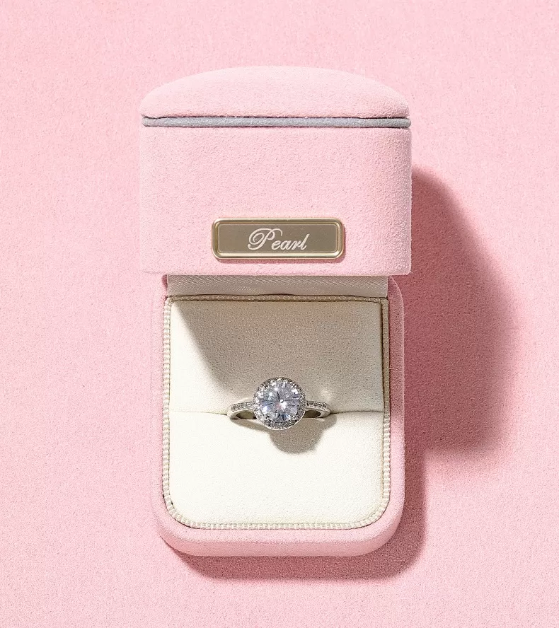 Tender pink microfiber ring box with grey trim and gold bar