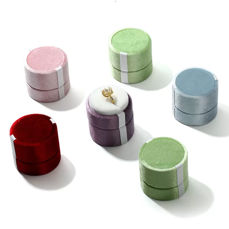 Open view of round lace jewelry box with velvet insert