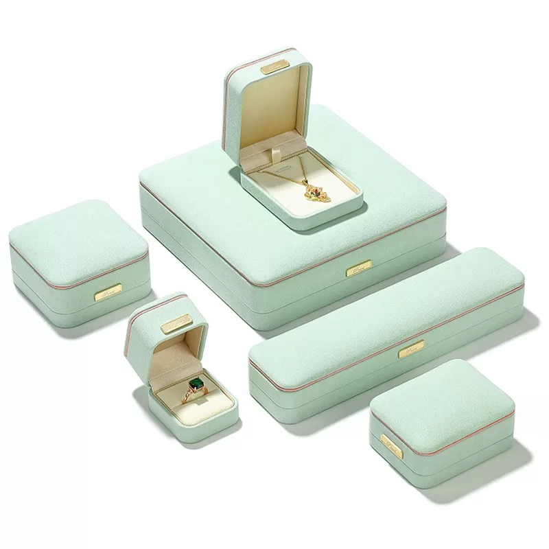 Mint green suede pendant box with beige interior for jewelry