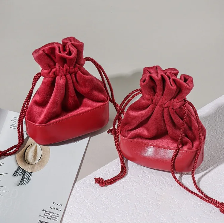 Spliced velvet and leather jewelry pouch in green with round bottom