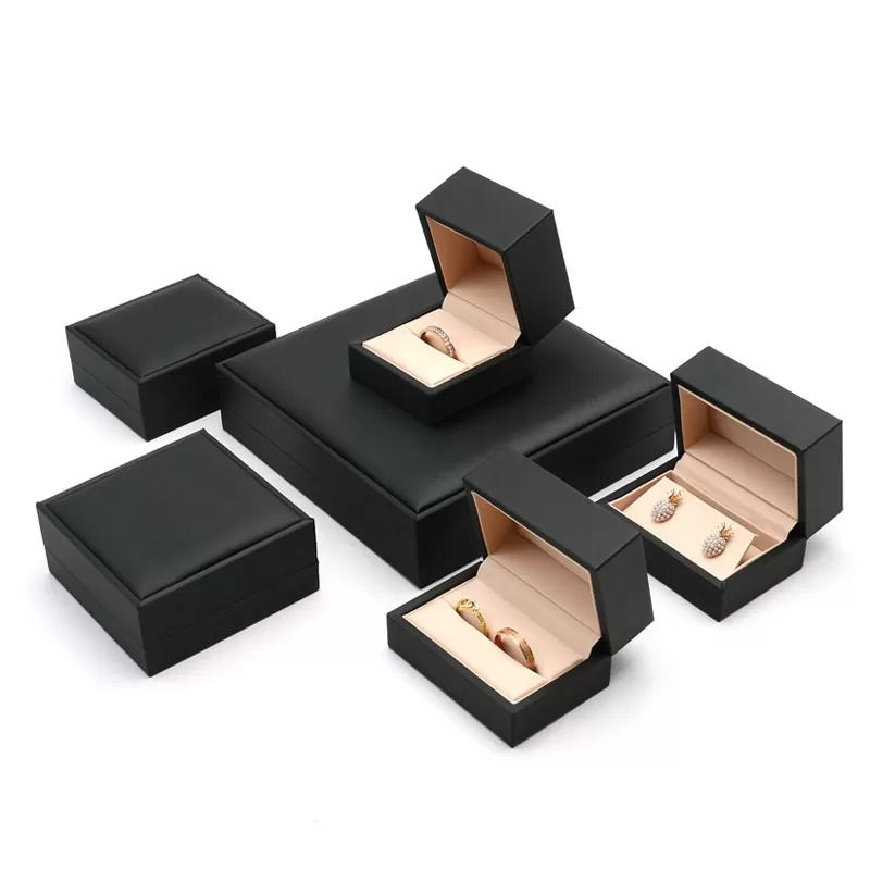 Complete set of black brushed leatherette jewelry boxes with rose gold interior