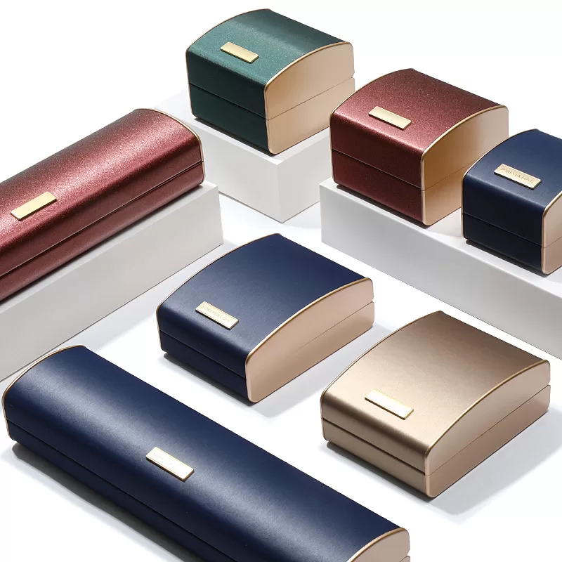 Set of brushed rose gold jewelry boxes for rings, pendants, and bracelets.