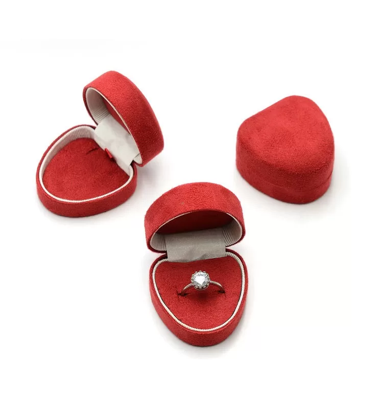 Open view of luxury heart-shaped ring box with suede lining