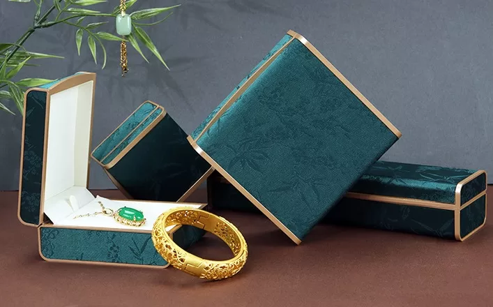 Closed red brocade jewelry chest with traditional Chinese button