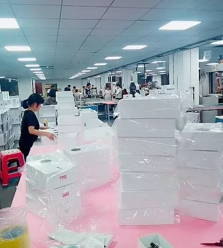 Workers assembling custom paper jewelry set boxes for bulk orders